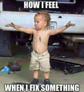 A young boy looking triumphant in front of a car with no shirt on. The words "how I feel when I fix something" on the photo.